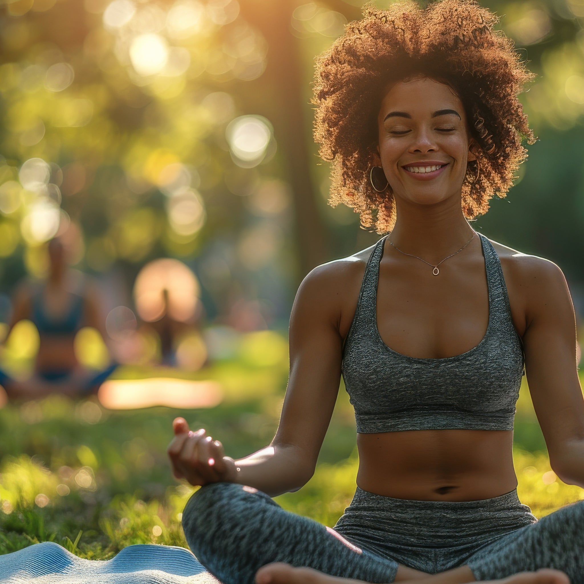 Woman practicing yoga in a park with trees and other people in the background